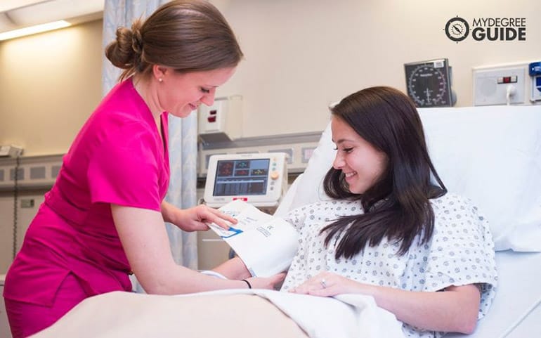 nurse getting blood pressure reading