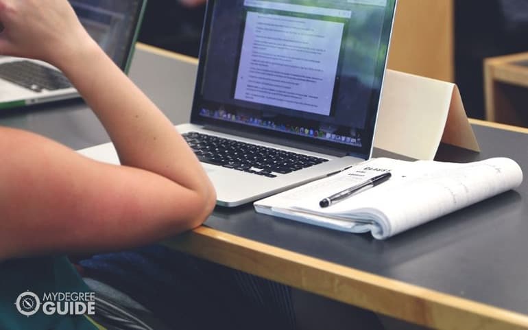 student doing homework on laptop