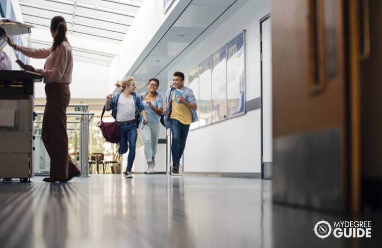 students running to their classroom in university building