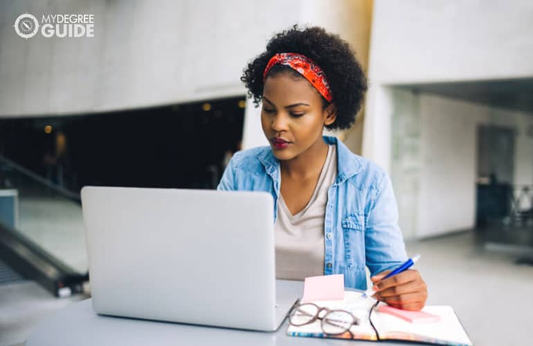 person studying on her computer