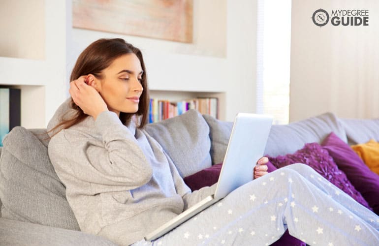 woman studying on her computer in pajamas