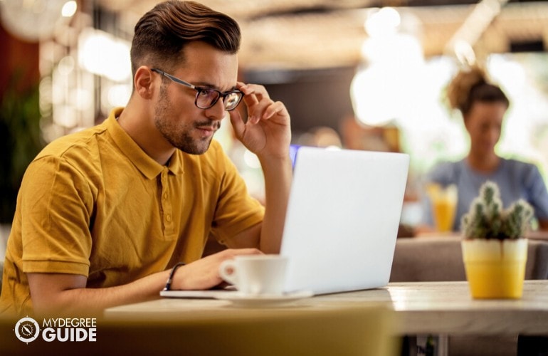 male adult studying on his computer