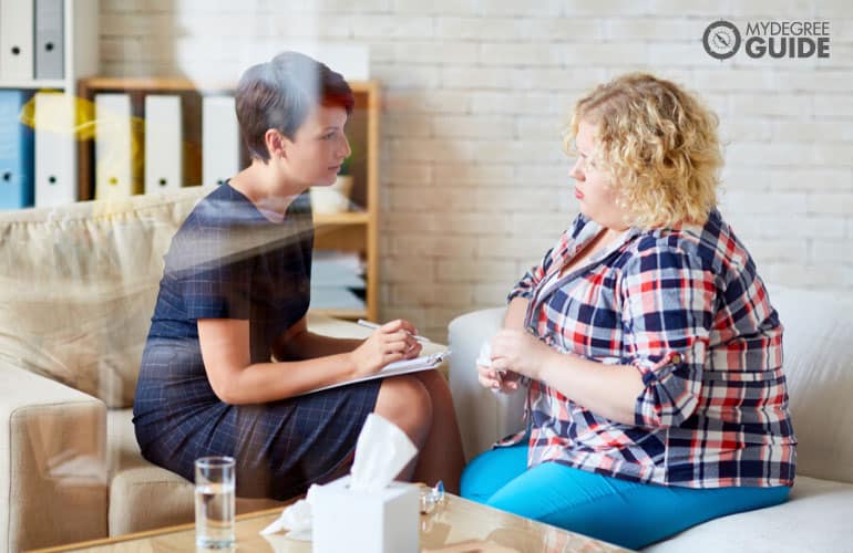 female psychologist talking to a patient in her office