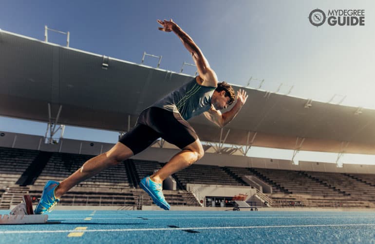 athlete running in a track field 