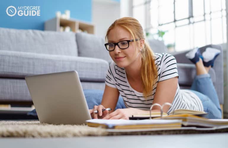 student studying on her computer at home