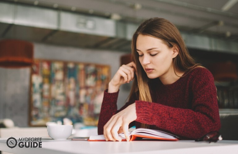 Accounting student studying online in a cafe