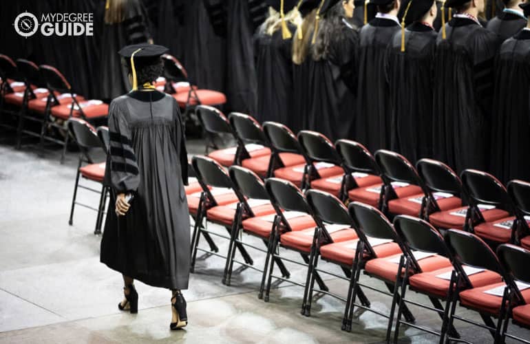 someone walking at a college graduation ceremony