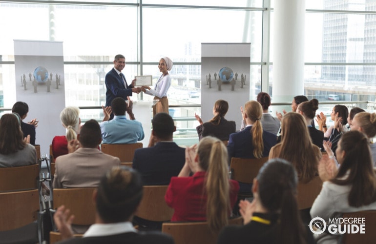 someone receiving a certificate at an award’s ceremony