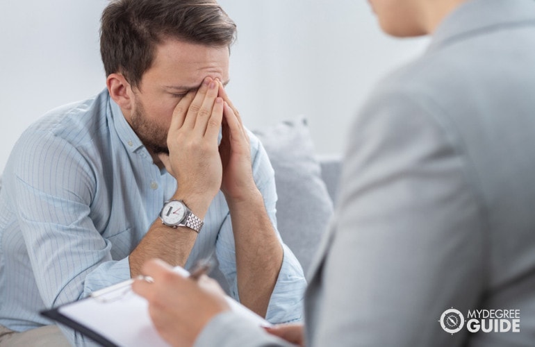 sad male patient during therapy session