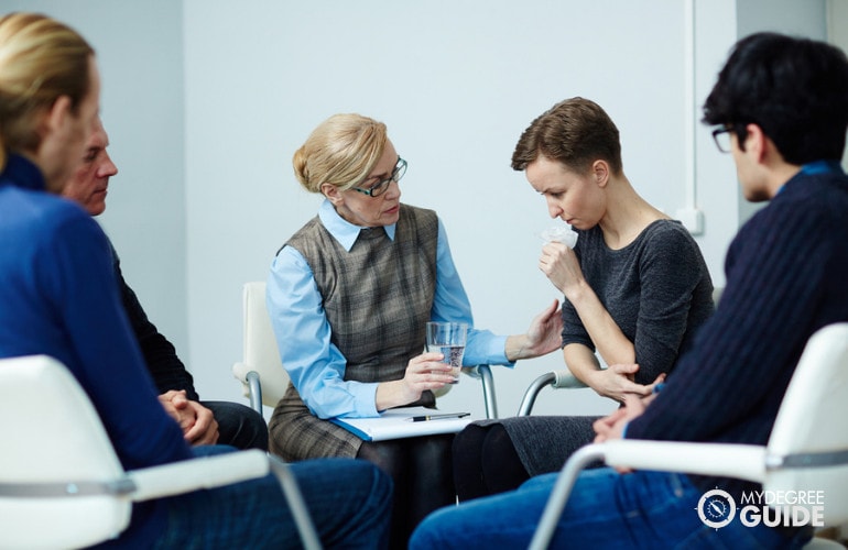 counselor comforting a patient during group counseling