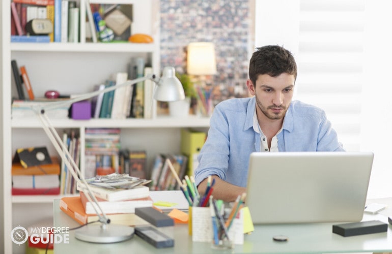 someone studying on his computer