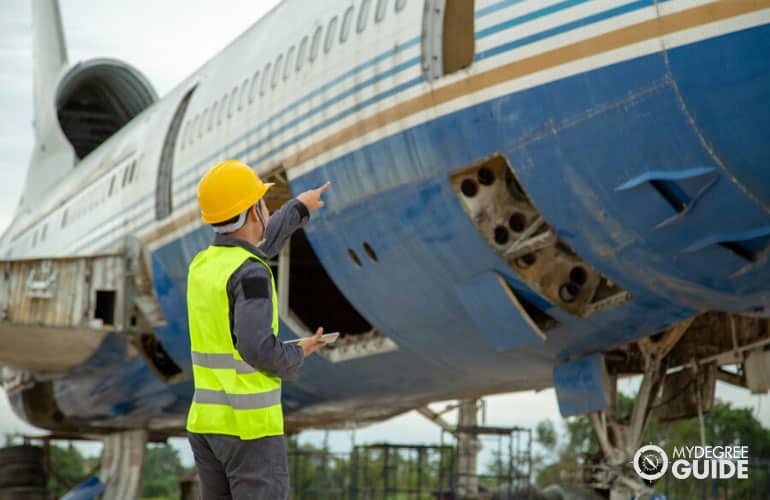 aerospace engineer checking a plane