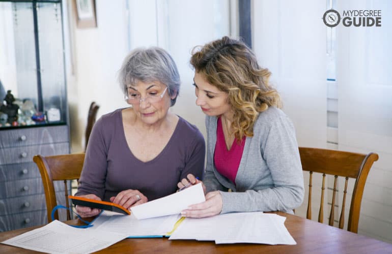 social worker helping an elderly woman