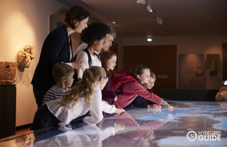 History teacher letting her students explore during a trip to museum