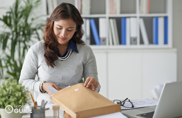 female mailing a large envelope