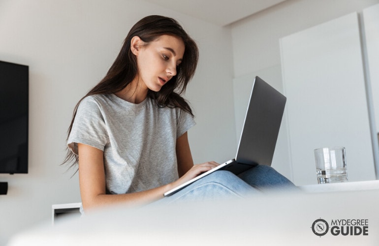 student working on her laptop at home