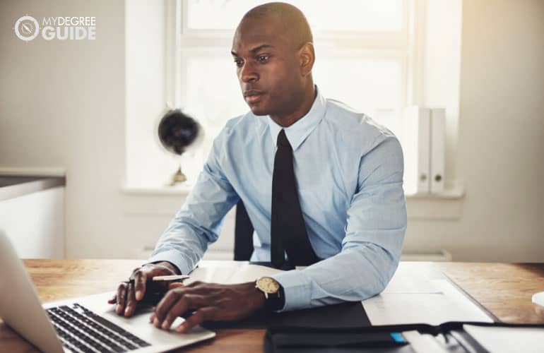 paralegal working on his computer in an office