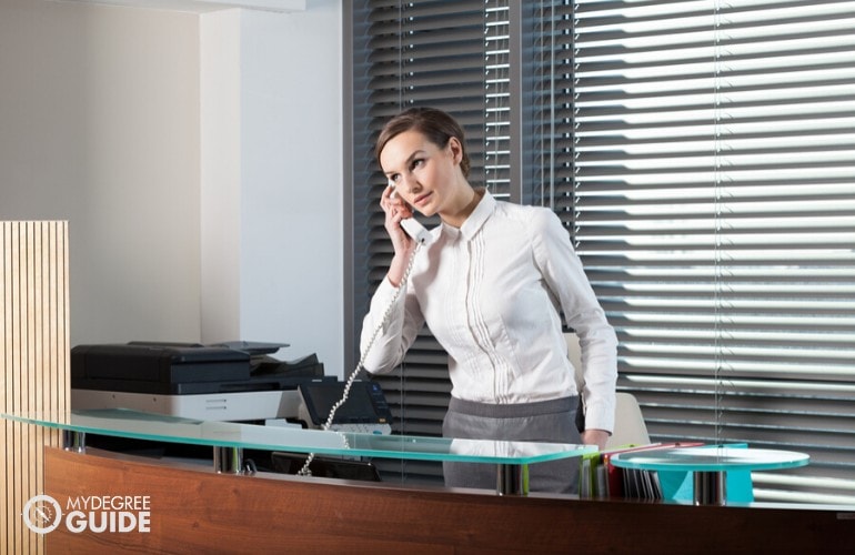 office receptionist talking to client on the phone