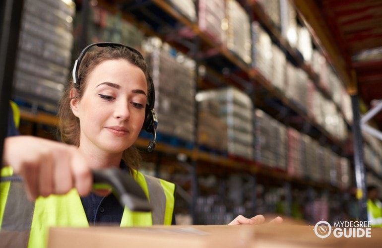 Logistician checking barcodes of products