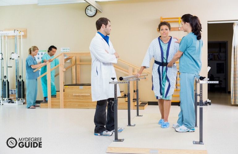 Physical therapist assistant helping a patient