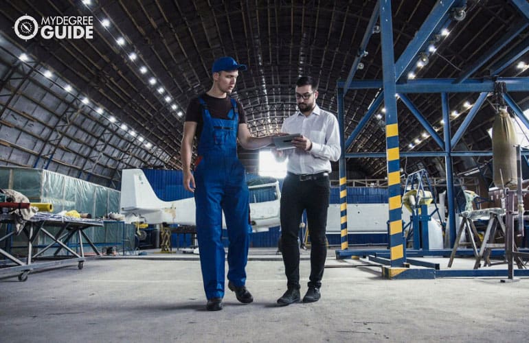 Aviation Manager having a discussion with an aircraft mechanic