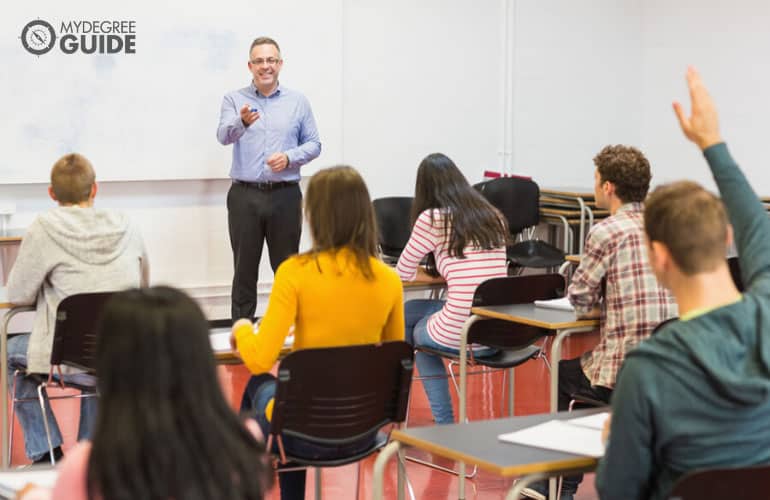 students listening to their teacher in a classroom