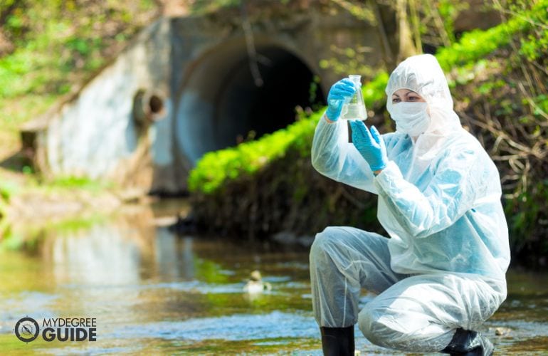 Hydrologist taking water samples from a river