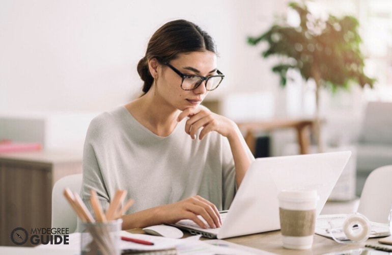 psychology degree student studying on her laptop