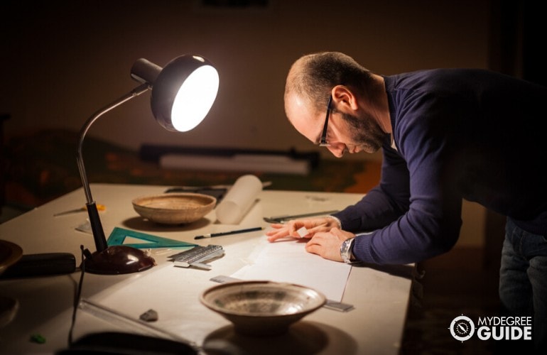 archaeologist working in his office