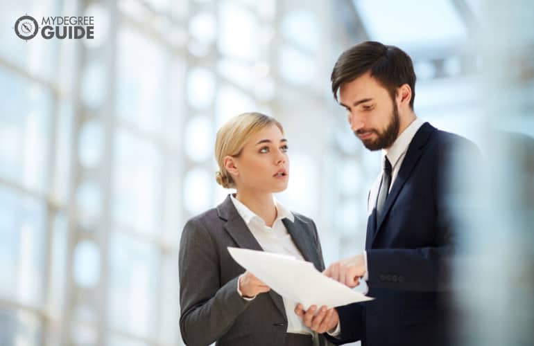 paralegal discussing some documents to a fellow paralegal