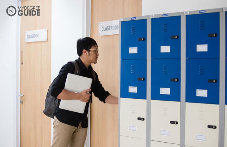 male student walking into a classroom