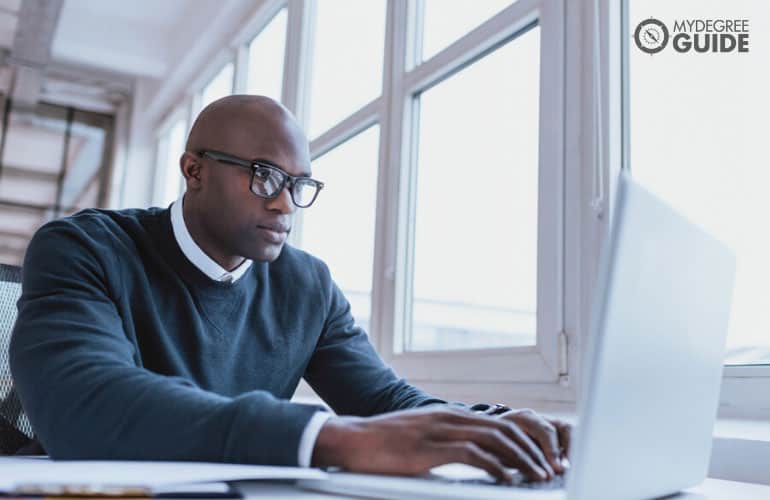 man working on his computer