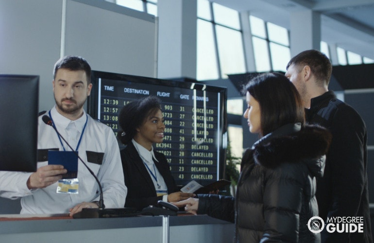 immigration officers checking passengers in airport