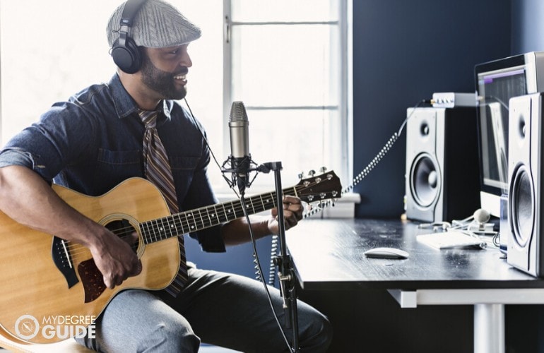 musician recording his music at home