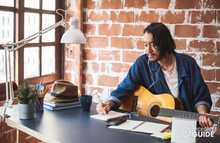 musician writing a song at home