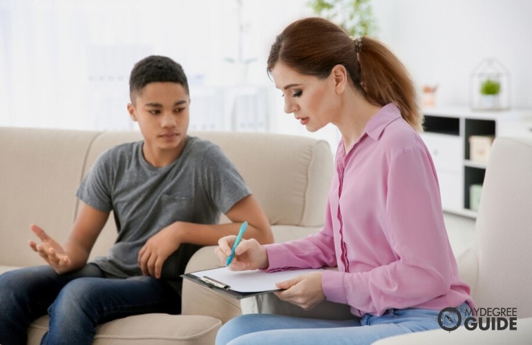 Psychologists listening to her patient during therapy session