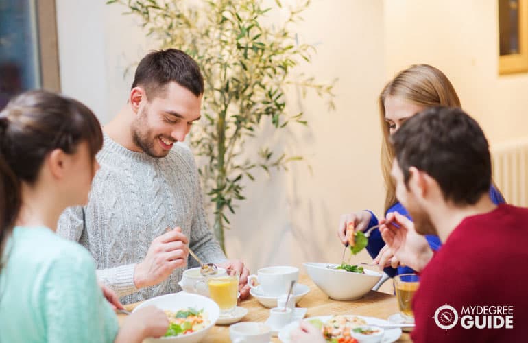 group of college friends talking over dinner