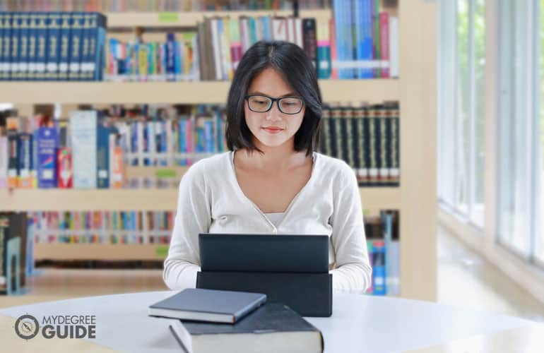 paralegal student studying in a law library