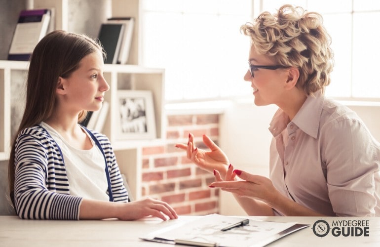 counselor talking to a child in her office