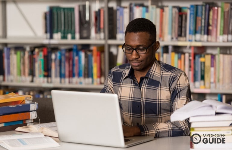 Education degree student studying at a library