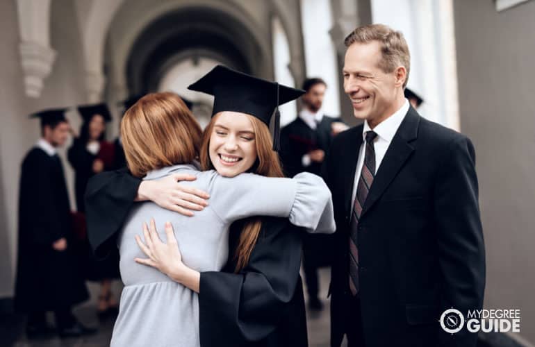 graduating associate degree student with her parents