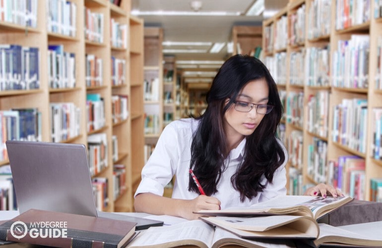 psychology student researching in library