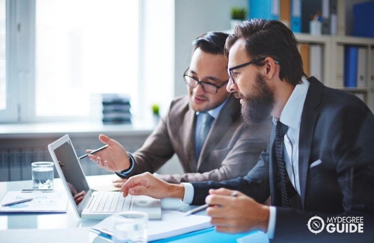 business administrators working together on a laptop