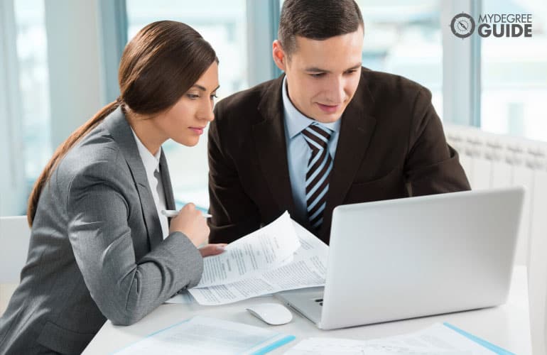 business consultants working together on a laptop