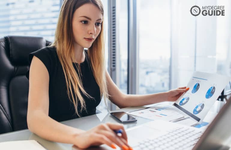 business analyst working on her computer in an office