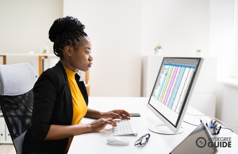 Business Intelligence Analyst working on her computer