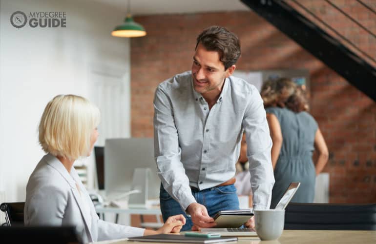 business manager talking to a colleague in an office