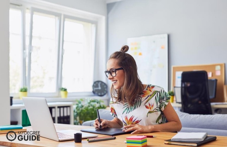 Graphic designer working in her office