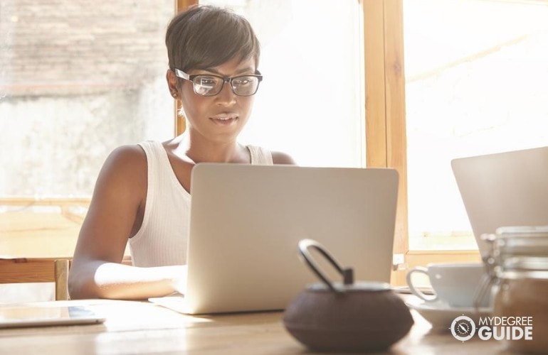 PhD in International Business student studying on her laptop