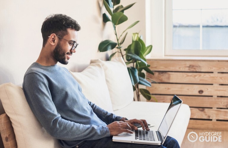 sociology degree student studying on his laptop at home